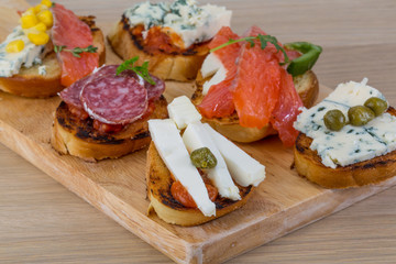 Tapas with cheese, salami and salmon