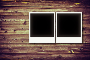 Fototapeta premium Photo frames on vintage wooden board background texture