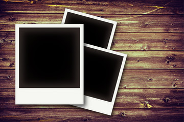 Photo frames on vintage wooden board background texture