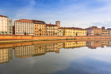 Naklejka premium Old town of Pisa with reflection in Arno river, Italy