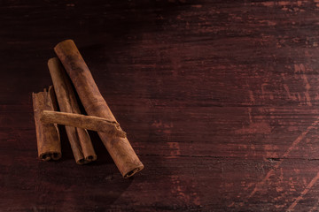 whole cinnamon sticks on wooden background