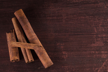 whole cinnamon sticks on wooden background