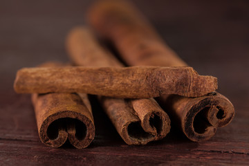 whole cinnamon sticks on wooden background