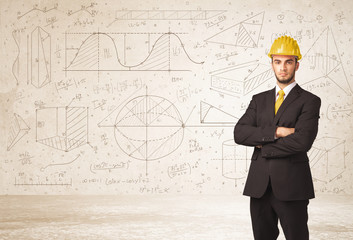 Handsome engineer calculating with hand drawn background