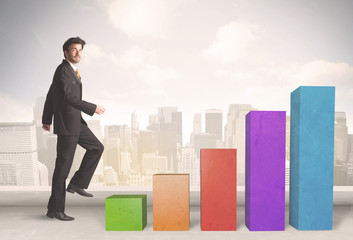 Business person climbing up on colourful chart pillars concept