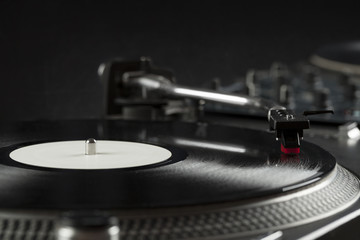 Turntable playing vinyl close up with needle on the record