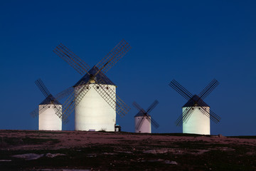 Fototapeta na wymiar windmills at field in night