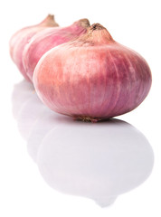 Large red onion over white background