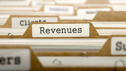 Revenues Concept with Word on Folder.