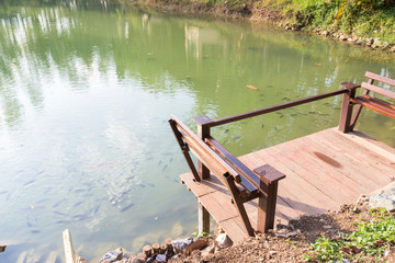 wooden bench beside the  lake