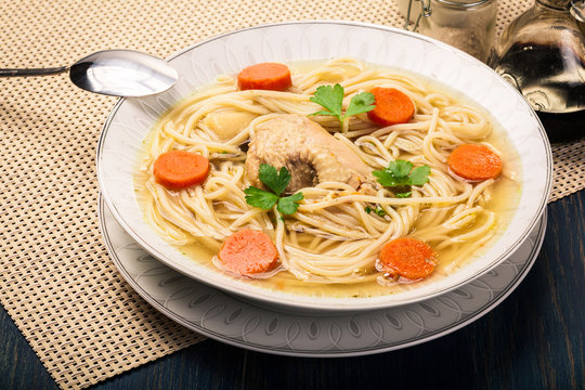 Chicken broth with noodles and carrot