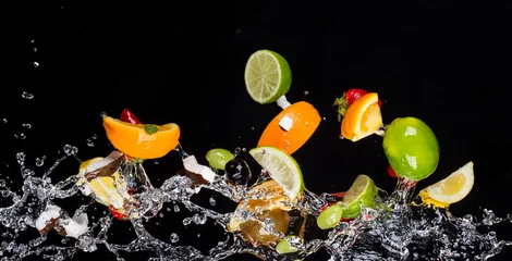 Foto op Canvas Mix of fruits with water splashes on black © Jag_cz