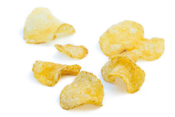 Close-up of several potato chips, isolated on white background