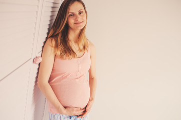 young happy pregnant woman at home