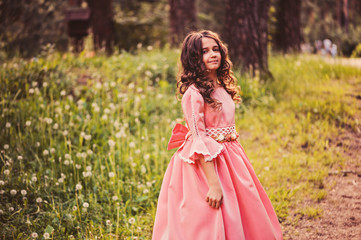 child girl in fairytale princess dress in summer forest