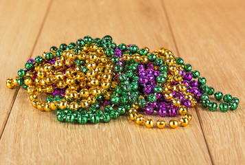 Purple, green and gold Mardi Gras beads. © Oleksii Sergieiev