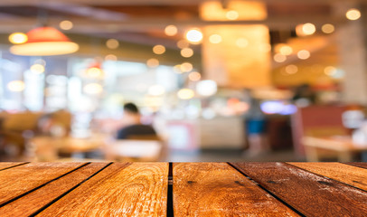 Empty wood table and Coffee shop blur background with bokeh imag