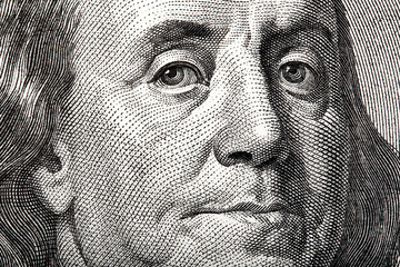 Portrait of Ben Franklin on the US $100 dollar bill in macro. - obrazy, fototapety, plakaty
