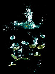 coins falling down to water