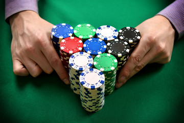 dealer moves poker chips