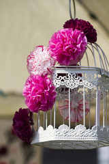 handmade paper flowers on the cage
