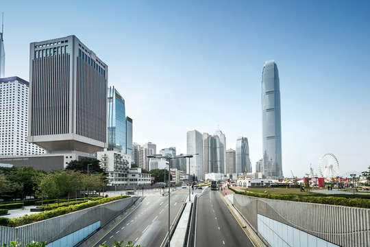 traffic and buildings at modern city hong kong during daytime.