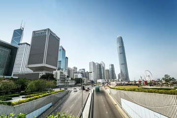 Fototapeta na wymiar traffic and buildings at modern city hong kong during daytime.