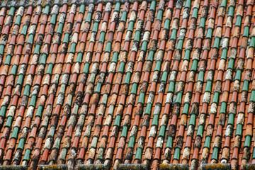 roof tiles of different colors in the old building of Coimbra Po