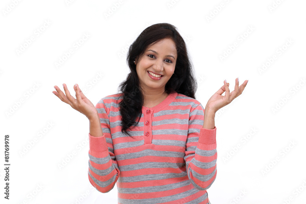 Wall mural Happy young woman gesturing an open hands against white backgrou