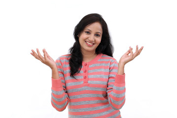 Happy young woman gesturing an open hands against white backgrou