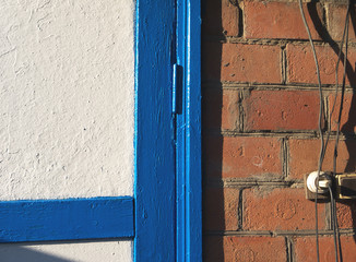 part of a brick wall and painted door