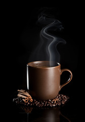 aromatic cup of coffee with smoke and beans
