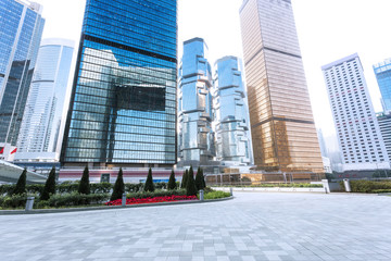 Naklejka premium empty pavement and skyscrapers in modern city