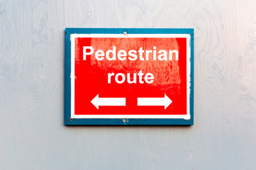 Pedestrian route direction red painted notice board