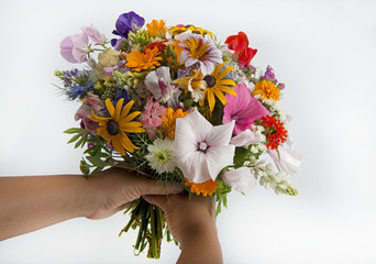 holding a summer flower bouquet at white background