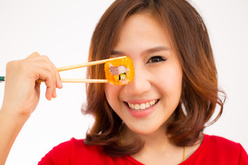 Close-up. young lady eating sushi roll