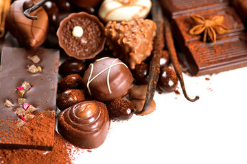 Chocolate border over white. Variety of praline sweets