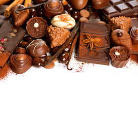 Chocolate border over white. Variety of praline sweets
