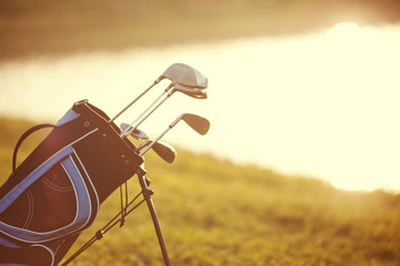 Professional golf gear on the golf course at sunset near lake