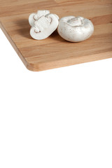 Champignons on a wooden board, white background