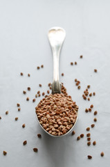 Buckwheat groats on a spoon. Selective focus.