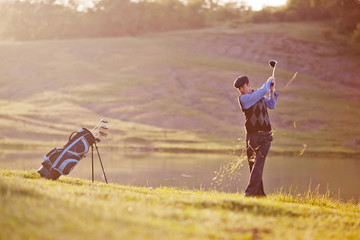 Male golf player. Golfing.