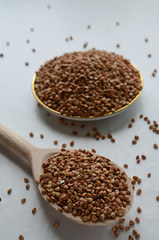 Buckwheat groats on a spoon. Selective focus.