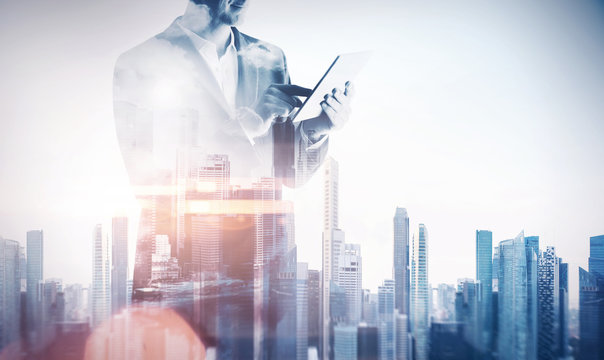 Double exposure with businessman using digital tablet. With spec