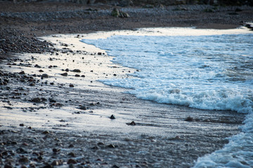 waves crushing over rocks in sunset