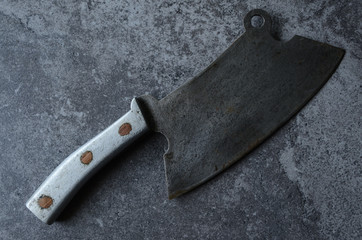 Vintage meat cleaver on stone table