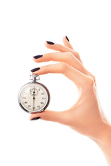 Female hand holding stopwatch set to thirty seconds, black nails