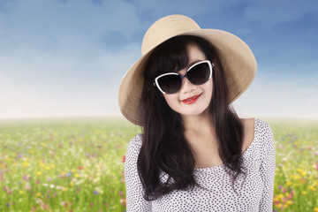 Beautiful woman with sunglasses at field