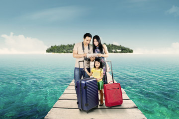 Fototapeta premium Happy family looking at digital map