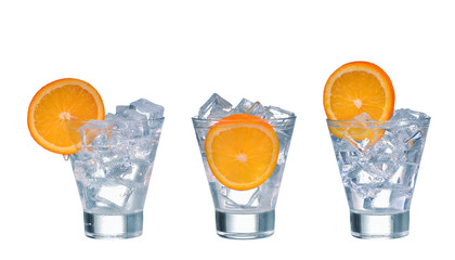 glass with ice cubes orange slice and water isolated